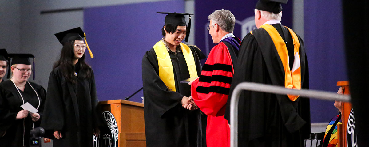 Students crossing the stage at Cornell College commencement 2023