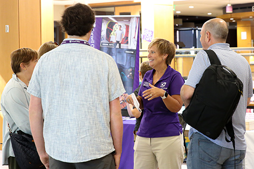 Families checking in at visit event
