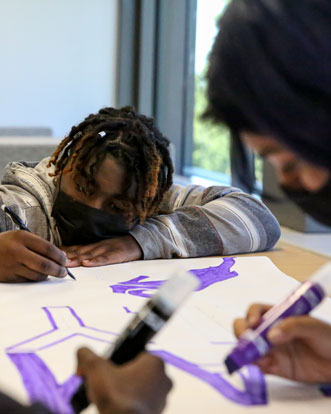 Cornell College students work on a project using their fine arts skills