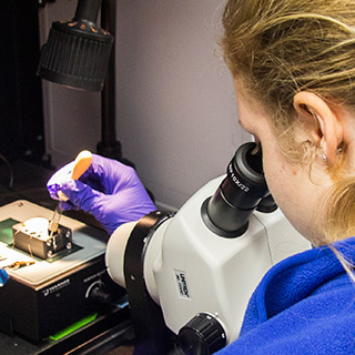 Student working with chemical analysis equipment