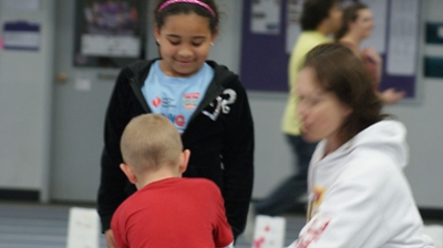A Cornell College student works with kids as part of the Lunch Buddies program