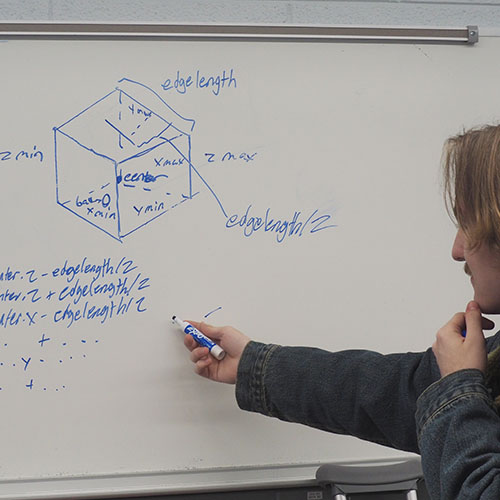 Student at white board in computer science classroom