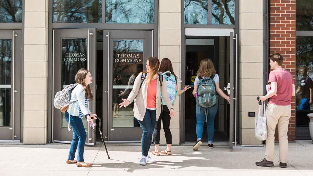 Cornell College students outside the entrance to the Thomas Commons