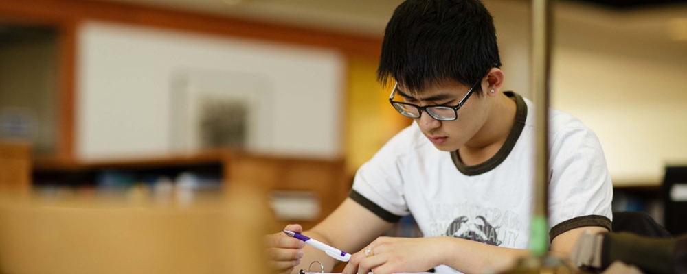 Cornell student studying in library