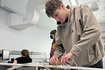 Student working on a fluid dynamics project