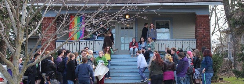 Students gather in front of house