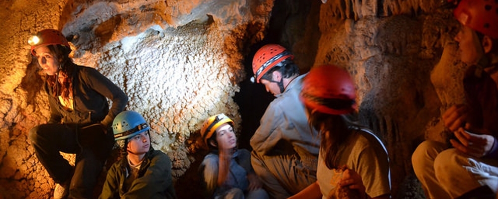 Geology student studies cave map. 