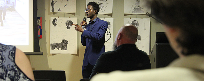 Student presentation in the Hall-Perrine Room in Thomas Commons