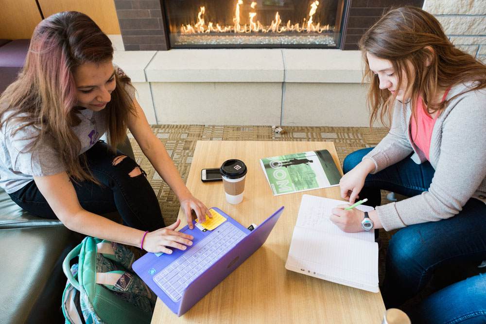 Cornell students working together at a table in Thomas Commons