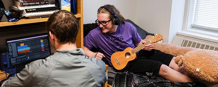 Two male students in residence hall room