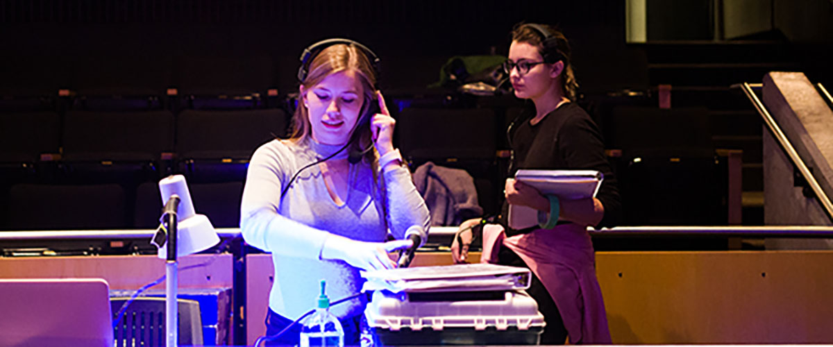 Student in production booth at Cornell College