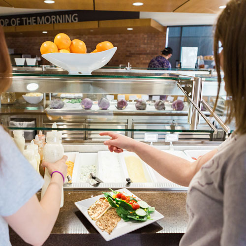 Cornell students select food from the salad bar